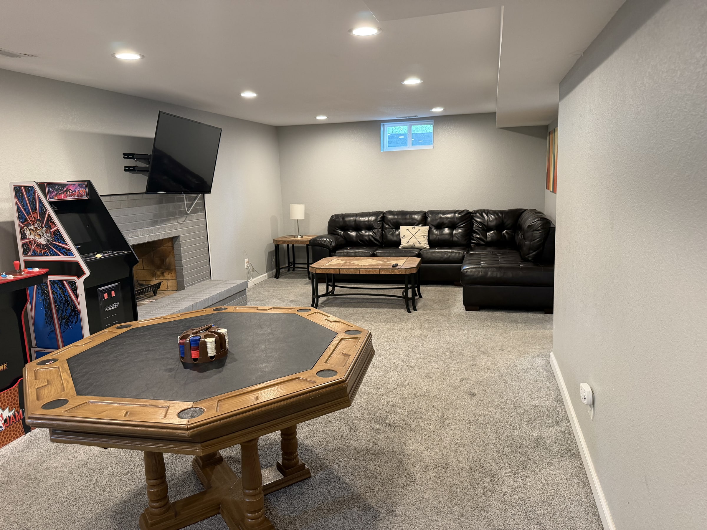 Game room with poker table, leather sofa, and clean carpet